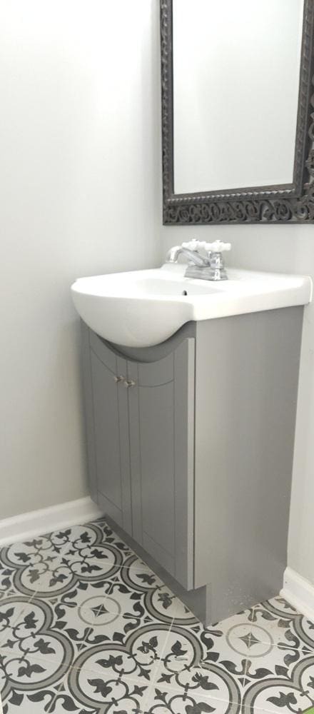 bathroom featuring tile patterned floors, vanity, and baseboards