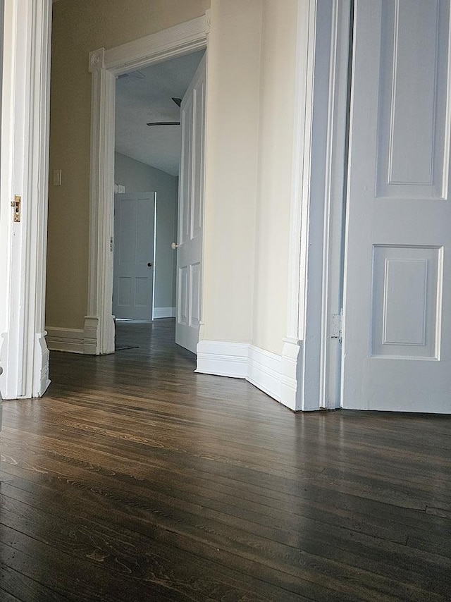 spare room with dark hardwood / wood-style floors and lofted ceiling