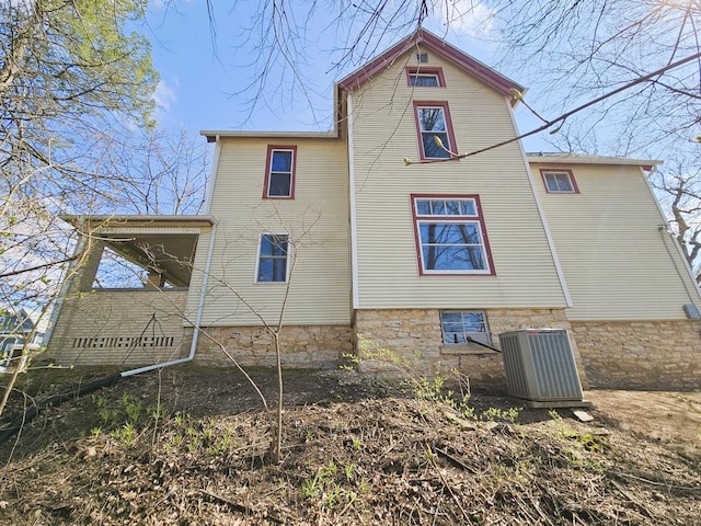 rear view of property featuring central AC
