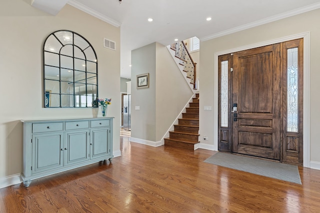 foyer entrance featuring crown molding and hardwood / wood-style floors