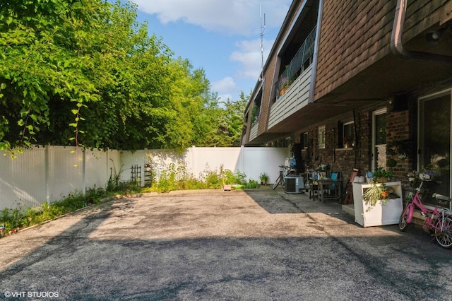 view of yard featuring a patio area, cooling unit, and a fenced backyard