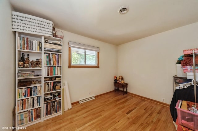 recreation room with visible vents, baseboards, and wood finished floors