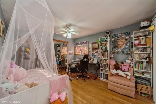 bedroom with a closet, a ceiling fan, and wood finished floors