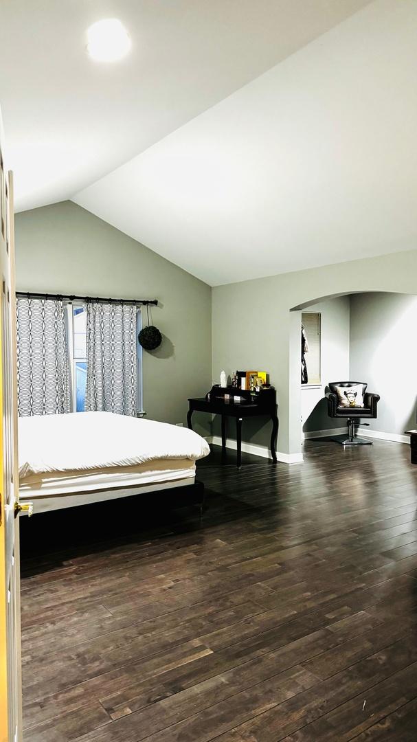 bedroom featuring lofted ceiling and dark wood-type flooring