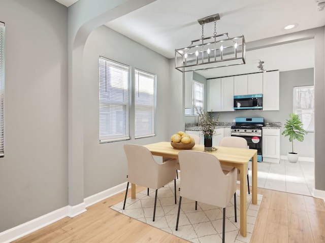 dining space with light hardwood / wood-style flooring