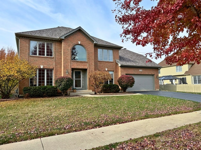 view of front facade with a garage and a front yard