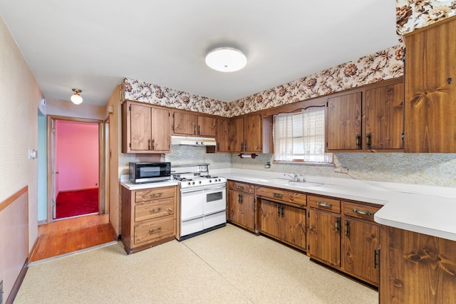 kitchen featuring sink and range with two ovens