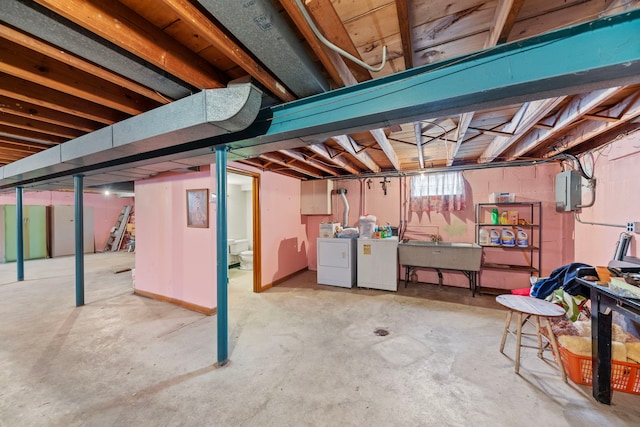 basement featuring sink and washer and clothes dryer