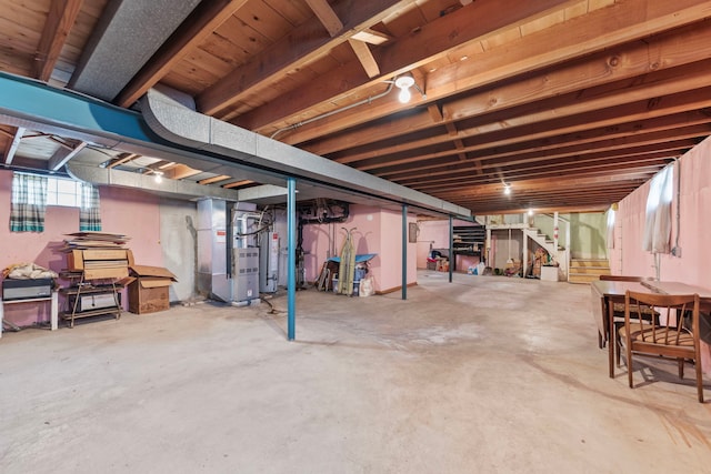 basement featuring heating unit and water heater