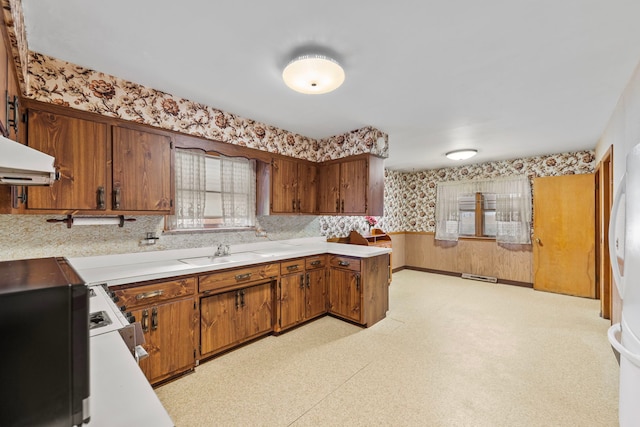 kitchen featuring sink and white range with gas cooktop