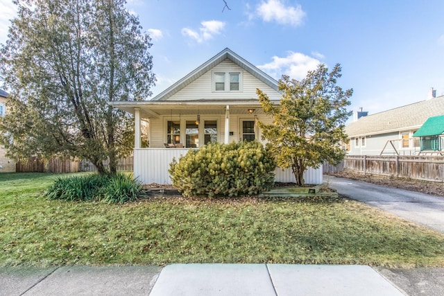 bungalow featuring a porch and a front lawn