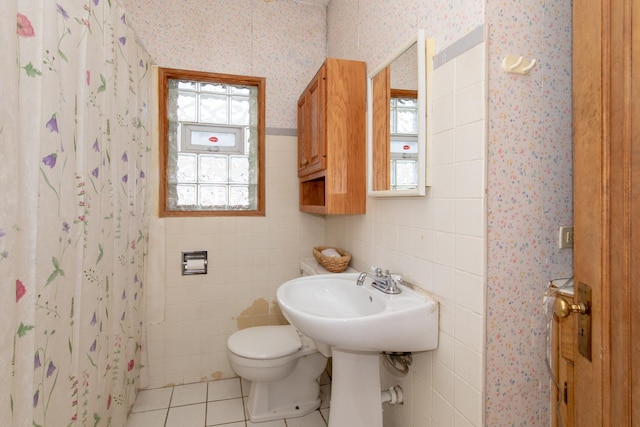 bathroom with toilet, a shower with shower curtain, tile patterned floors, and sink