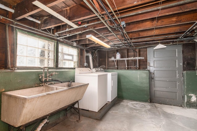 basement with washer and clothes dryer and sink