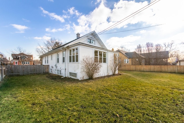 back of house with a yard