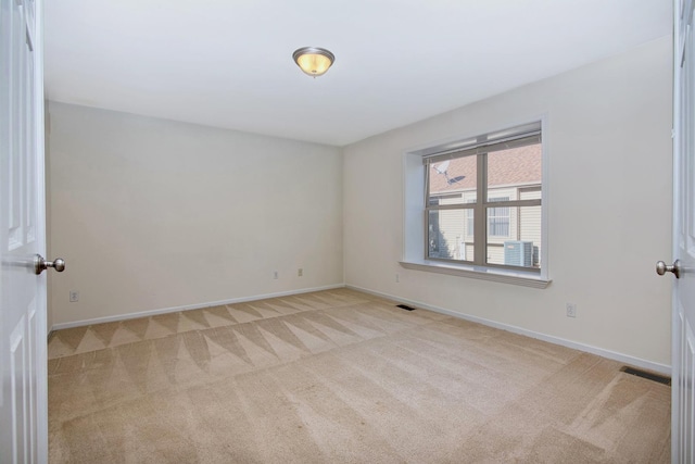 unfurnished room featuring light colored carpet