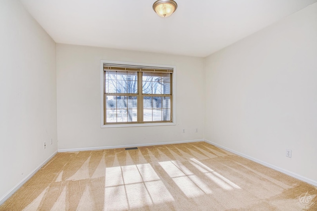 empty room with light colored carpet