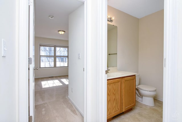 bathroom with toilet and vanity