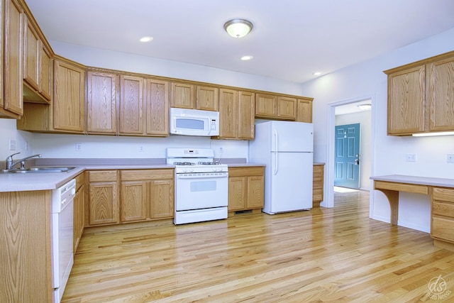 kitchen featuring sink, white appliances, and light hardwood / wood-style flooring