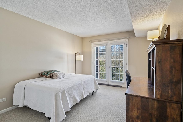 bedroom with light carpet, a textured ceiling, and access to exterior