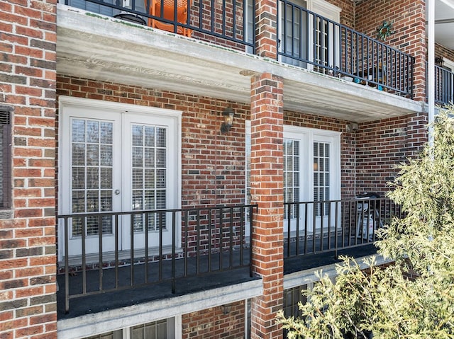 doorway to property with a balcony and french doors