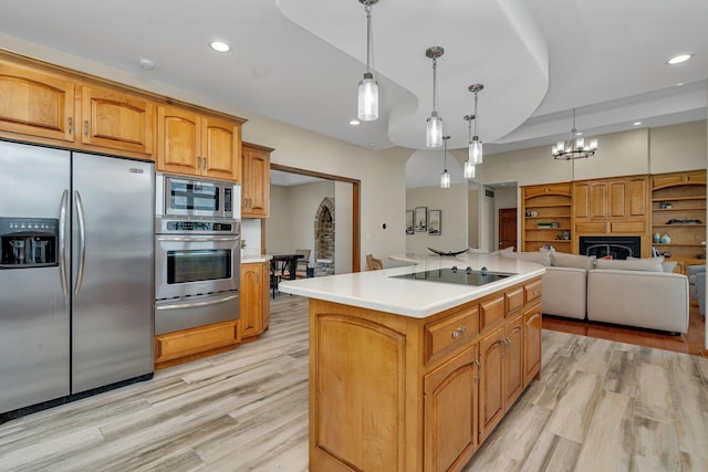 8726 E Goodfarm Rd, Gardner, IL 60424 - kitchen featuring appliances with stainless steel finishes, a warming drawer, light countertops, a center island, and light wood finished floors