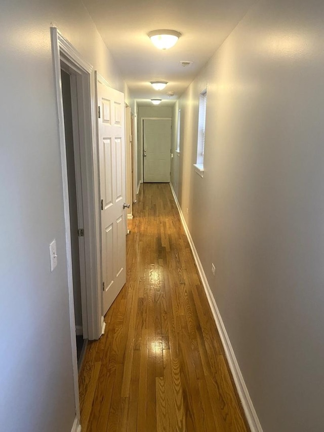 hallway with wood-type flooring