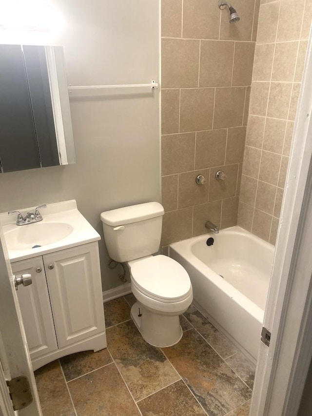 full bathroom with vanity, toilet, and tiled shower / bath combo