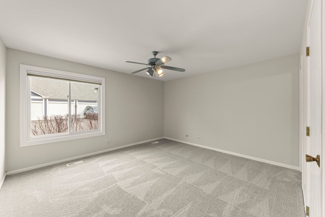 carpeted spare room with ceiling fan