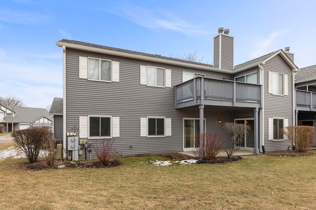 back of house featuring a patio and a yard