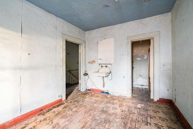 unfurnished room featuring sink