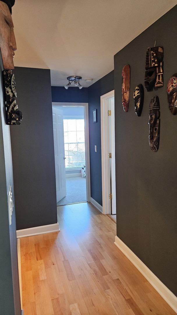 hallway with light hardwood / wood-style floors