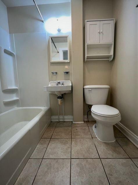 bathroom featuring toilet, shower / bath combination, and tile patterned floors