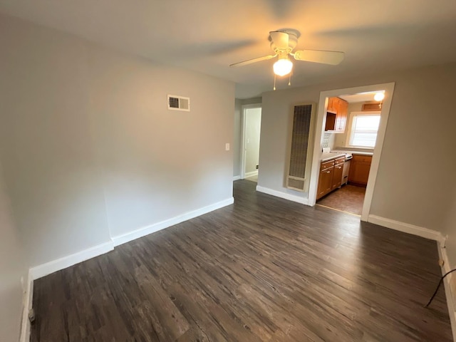 unfurnished room with ceiling fan and dark wood-type flooring