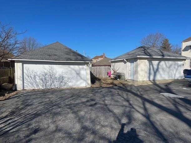 exterior space with a garage and an outbuilding