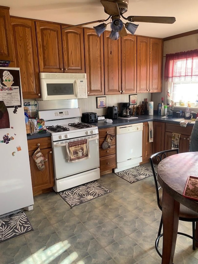 kitchen with ceiling fan, white appliances, and ornamental molding