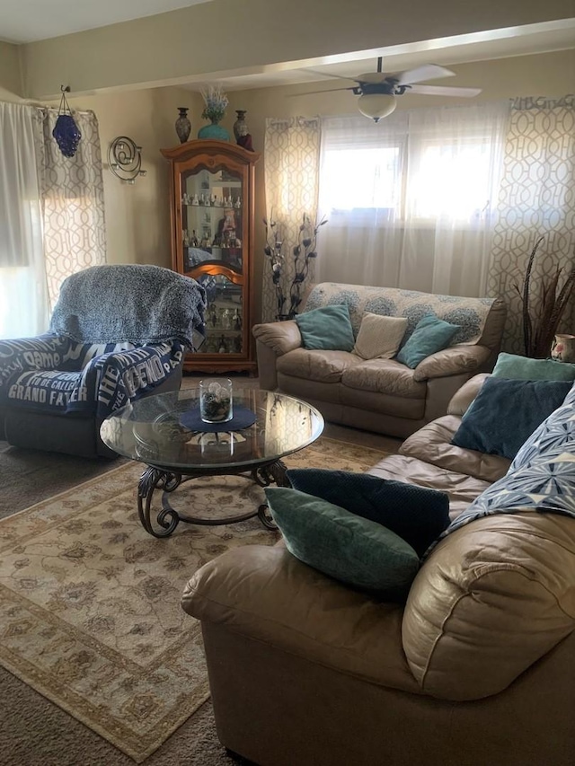 carpeted living room featuring ceiling fan