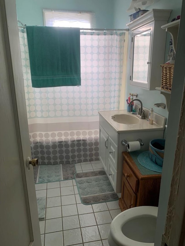 bathroom featuring shower / bath combo with shower curtain, vanity, and tile patterned flooring