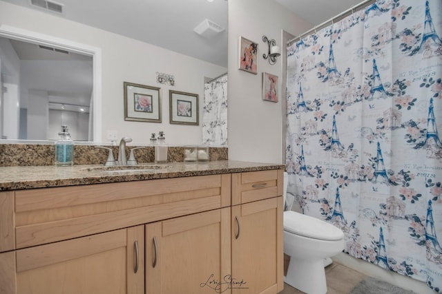 bathroom featuring tile patterned floors, a shower with curtain, vanity, and toilet