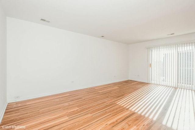 spare room featuring light hardwood / wood-style flooring