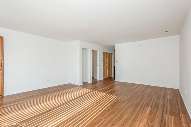 unfurnished room with hardwood / wood-style floors