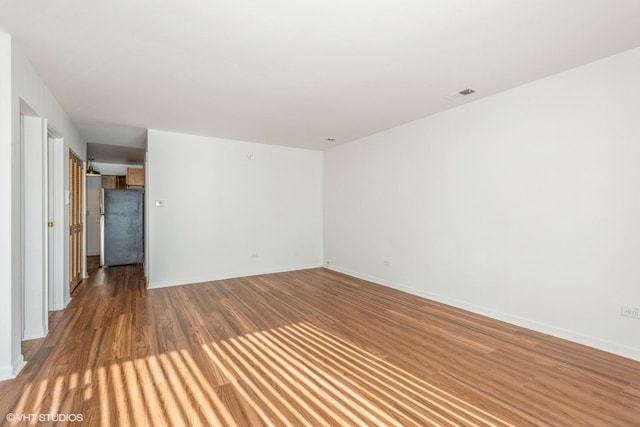 spare room with hardwood / wood-style floors