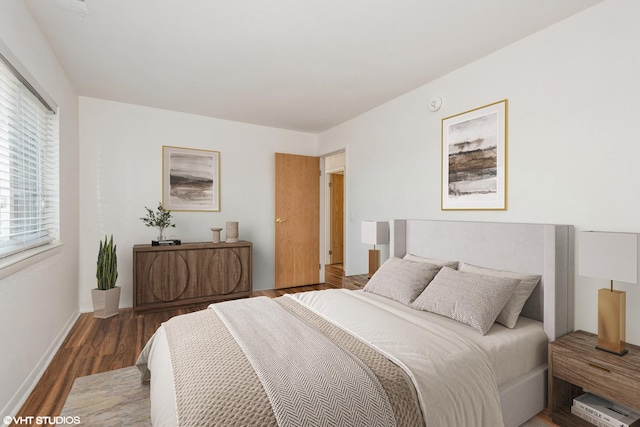 bedroom with dark wood-type flooring