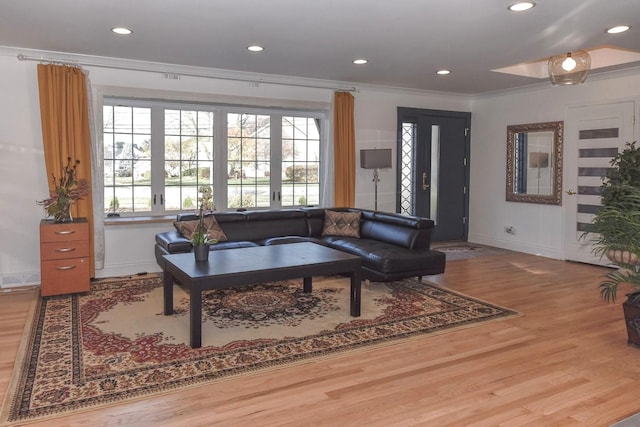 living room with hardwood / wood-style floors, french doors, and ornamental molding