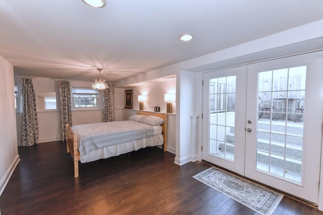 bedroom featuring dark hardwood / wood-style flooring, multiple windows, access to outside, and french doors