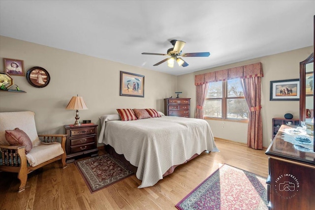 bedroom with ceiling fan and light hardwood / wood-style flooring