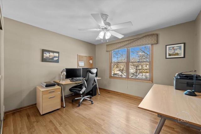 office area with light wood-type flooring and ceiling fan