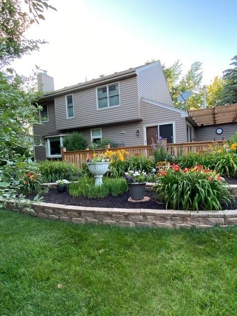 exterior space with a front lawn and a wooden deck