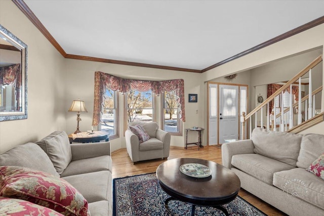 living room featuring light wood-type flooring, plenty of natural light, and crown molding