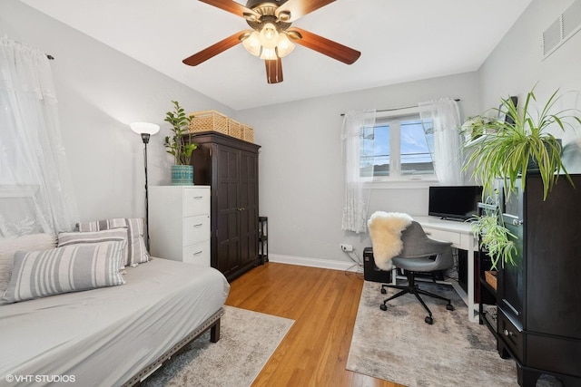 bedroom with ceiling fan and light hardwood / wood-style floors