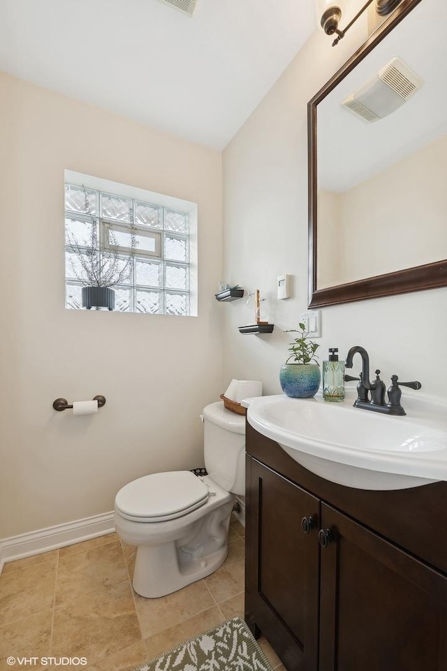 bathroom with vanity, tile patterned floors, and toilet